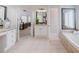 Beautifully tiled bathroom featuring double vanity sinks, granite countertops, and seamless flow from bedroom at 200 Long Needle Ct, Sugar Hill, GA 30518