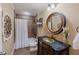Updated bathroom featuring a tiled shower, decorative mirror, vanity, and stylish decor at 200 Long Needle Ct, Sugar Hill, GA 30518