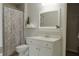 Neat bathroom with white vanity, toilet and a shower tub at 200 Long Needle Ct, Sugar Hill, GA 30518