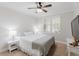 Comfortable bedroom with natural light, ceiling fan, and neutral decor at 200 Long Needle Ct, Sugar Hill, GA 30518