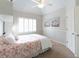 Serene bedroom with neutral paint and carpet, ceiling fan and wide window at 200 Long Needle Ct, Sugar Hill, GA 30518