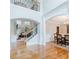 Elegant entryway with hardwood floors, staircase with iron spindles, and views into the living and dining rooms at 200 Long Needle Ct, Sugar Hill, GA 30518