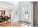 Bright and airy foyer with hardwood floors, wainscoting, and a view of the dining room at 200 Long Needle Ct, Sugar Hill, GA 30518