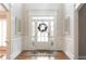 Inviting foyer featuring hardwood floors, a front door with sidelights, and decorative mirrors at 200 Long Needle Ct, Sugar Hill, GA 30518