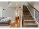 Welcoming foyer with hardwood floors, staircase, and a view into the living room at 200 Long Needle Ct, Sugar Hill, GA 30518