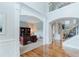 Elegant foyer with hardwood floors and arched entryways, showcasing an office and staircase at 200 Long Needle Ct, Sugar Hill, GA 30518