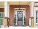 Welcoming front entrance featuring a beautiful wreath and symmetrical potted plants at 200 Long Needle Ct, Sugar Hill, GA 30518