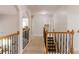 Upstairs hallway featuring wood and wrought iron railing and neutral decor at 200 Long Needle Ct, Sugar Hill, GA 30518