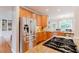 Bright kitchen showcases stainless steel appliances, granite countertops, and ample cabinet space at 200 Long Needle Ct, Sugar Hill, GA 30518