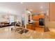 Well-appointed kitchen featuring a central island, granite countertops, and views into the adjacent dining area at 200 Long Needle Ct, Sugar Hill, GA 30518