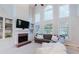 Inviting living room featuring a cozy fireplace, large windows, and comfortable seating arrangement at 200 Long Needle Ct, Sugar Hill, GA 30518