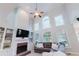 Bright living room with large windows, fireplace, and built-in shelving, perfect for relaxation and entertainment at 200 Long Needle Ct, Sugar Hill, GA 30518