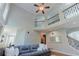 Sunlit living room featuring high ceilings, unique architectural details, and a seamless flow into other living areas at 200 Long Needle Ct, Sugar Hill, GA 30518