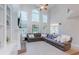 Open-concept living room with lots of natural light, a cozy fireplace, and ample space for entertaining at 200 Long Needle Ct, Sugar Hill, GA 30518