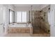 Elegant main bathroom featuring a soaking tub, tiled shower, and neutral finishes at 200 Long Needle Ct, Sugar Hill, GA 30518