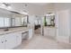 Spacious main bathroom featuring dual vanities and mirrors, with a view to the main bedroom at 200 Long Needle Ct, Sugar Hill, GA 30518