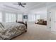 Bright main bedroom with sitting area, bathed in natural light from shuttered windows at 200 Long Needle Ct, Sugar Hill, GA 30518