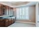 Bright office space featuring custom cabinetry and modern shutters for optimal natural light control at 200 Long Needle Ct, Sugar Hill, GA 30518
