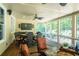 Relaxing screened porch with stylish furniture, ceiling fans, and an inviting atmosphere at 200 Long Needle Ct, Sugar Hill, GA 30518