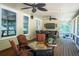 Relaxing screened porch with stylish furniture, ceiling fans, and an inviting atmosphere at 200 Long Needle Ct, Sugar Hill, GA 30518