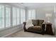 Cozy sitting area with loveseat and lamp, next to shuttered windows at 200 Long Needle Ct, Sugar Hill, GA 30518