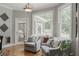 Cozy sunroom with large windows offering ample natural light and comfortable seating at 200 Long Needle Ct, Sugar Hill, GA 30518
