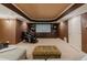 Cozy home theater with built-in shelving, a projector screen, and comfortable seating at 200 Long Needle Ct, Sugar Hill, GA 30518