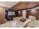 Finished basement theater featuring a projector, screen, custom cabinet and reclining chair at 200 Long Needle Ct, Sugar Hill, GA 30518