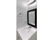 Bathroom showcasing a classic white vanity, framed mirror, and modern chrome fixtures at 3637 Chinaberry Ln, Snellville, GA 30039