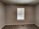 Neutrally decorated bedroom features new wood flooring and a window providing natural light at 3637 Chinaberry Ln, Snellville, GA 30039