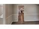 Hallway view of an open kitchen featuring white cabinets and stainless steel appliances at 3637 Chinaberry Ln, Snellville, GA 30039