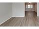 Open-concept space with gray walls, light vinyl flooring and large picture window to the next room at 3637 Chinaberry Ln, Snellville, GA 30039