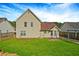 Backyard features a green lawn, a partial view of the home's rear, and a patio at 375 Shadetree Ln, Lawrenceville, GA 30044