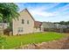 View of the backyard features a well-maintained lawn and a partial view of the home's rear at 375 Shadetree Ln, Lawrenceville, GA 30044