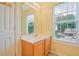 Bathroom with a single sink vanity, mirror, and window with natural lighting and a great view at 375 Shadetree Ln, Lawrenceville, GA 30044