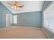 Bright bedroom featuring a ceiling fan, large windows, and neutral carpeting for a warm and inviting space at 375 Shadetree Ln, Lawrenceville, GA 30044