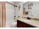 Cozy bathroom with decorative shower curtain, granite countertop vanity and a shower-tub combination at 3876 Thackary Dr, Powder Springs, GA 30127