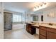 Elegant bathroom with double vanities, a separate shower, and a soaking tub at 3876 Thackary Dr, Powder Springs, GA 30127