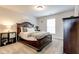 Bedroom with brown carpet, a queen sized bed, a nightstand, and a dresser at 3876 Thackary Dr, Powder Springs, GA 30127