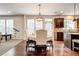 Dining area with wood floors, a chandelier, a telescope, and an open layout to the kitchen at 3876 Thackary Dr, Powder Springs, GA 30127