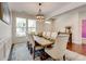 Bright dining area with an elegant table, chandelier, and ample natural light at 3876 Thackary Dr, Powder Springs, GA 30127