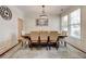 Formal dining room with elegant lighting fixture, neutral paint, and large windows at 3876 Thackary Dr, Powder Springs, GA 30127