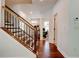 Bright entryway features hardwood floors, staircase with iron spindles, and an open view to the front of the home at 3876 Thackary Dr, Powder Springs, GA 30127