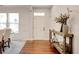 Bright foyer with hardwood floors, a stylish console table, and a view into the dining area at 3876 Thackary Dr, Powder Springs, GA 30127