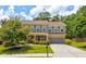Charming two-story home with lush green lawn and mature trees in a desirable neighborhood at 3876 Thackary Dr, Powder Springs, GA 30127
