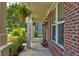 Cozy front porch with brick columns, hanging ferns, and decorative mushroom accents at 3876 Thackary Dr, Powder Springs, GA 30127