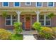 Inviting front porch featuring brickwork, decorative plants, and a welcoming front door with wreath at 3876 Thackary Dr, Powder Springs, GA 30127