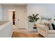 Hallway with a beige couch, a standing plant, and carpeted floors at 3876 Thackary Dr, Powder Springs, GA 30127