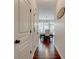 Hallway leading to a dining area with hardwood floors, a chandelier, and large windows at 3876 Thackary Dr, Powder Springs, GA 30127