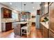 Charming kitchen with stainless appliances, dark cabinets and a kitchen island with bar stool seating at 3876 Thackary Dr, Powder Springs, GA 30127
